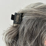 woman wearing acrylic claw clip in black