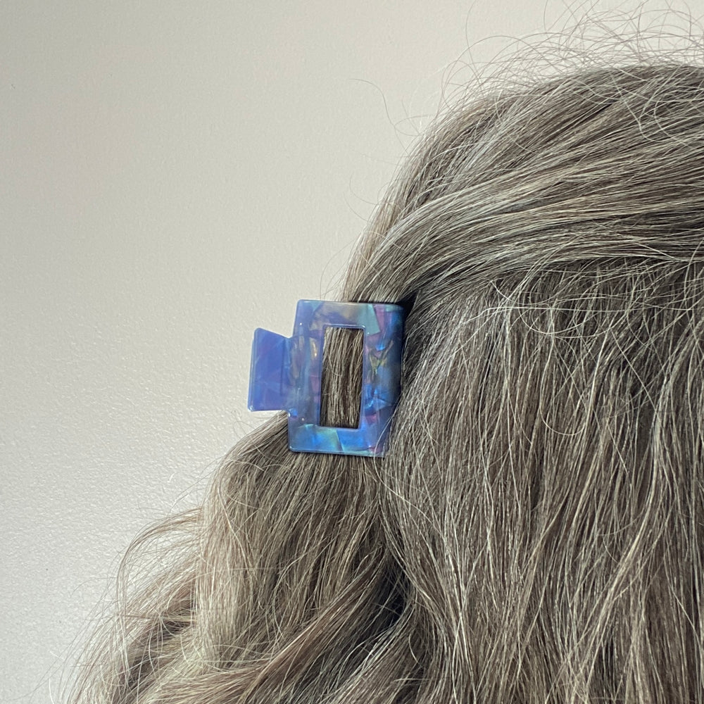 woman wearing acrylic claw clip in indigo blue