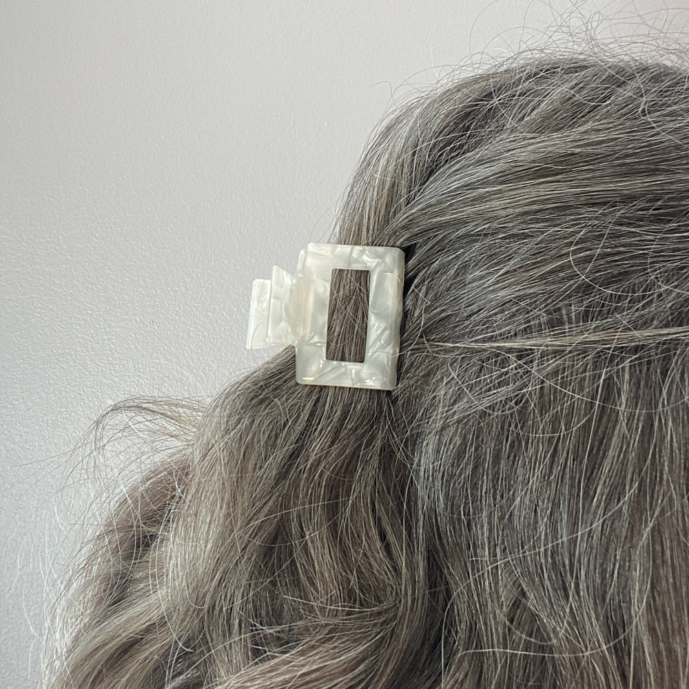 woman wearing acrylic claw clip in white