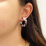 women wearing Mini acrylic hoop earrings in black and white 